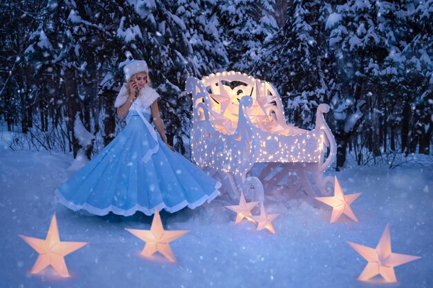 Photo beautiful woman as snow maiden with sled and stars