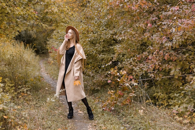 A beautiful woman in autumn clothes in nature. autumn blog