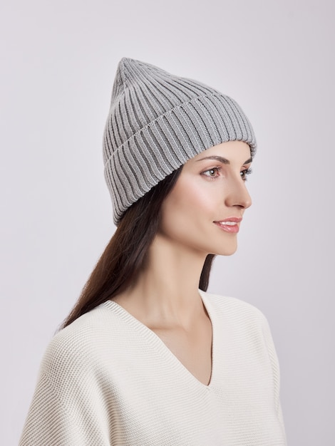 Beautiful woman in autumn hat on white background. Autumn warm clothes