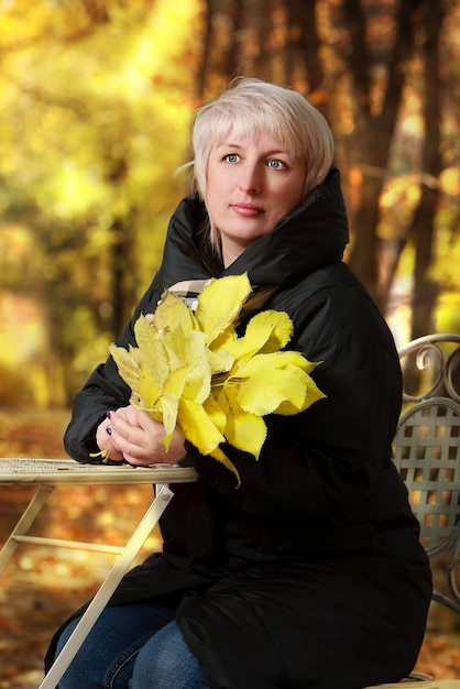 Beautiful woman in autumn park