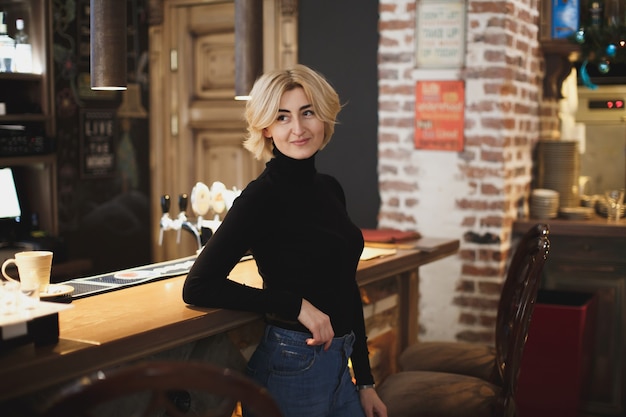 Beautiful woman bartender in the bar