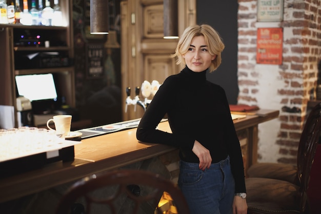 Beautiful woman bartender in the bar