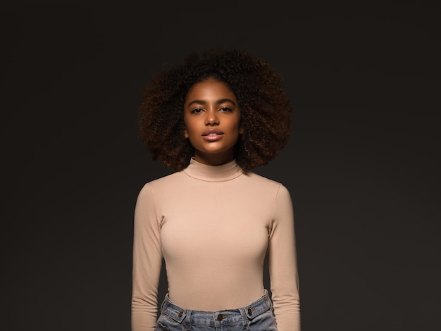 Beautiful woman black skin pretty african american beautiful model in sweater on black background.