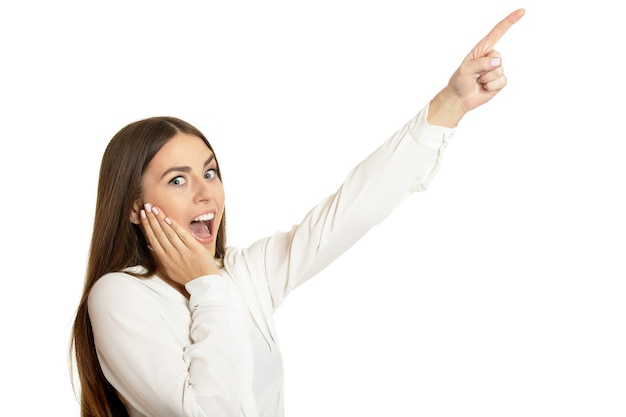 Beautiful woman in blouse pointing up white background