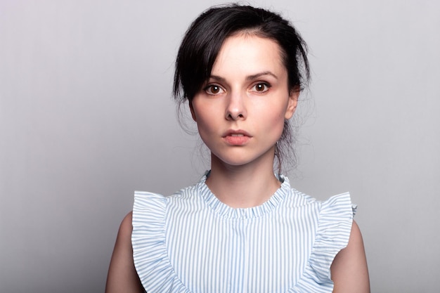 beautiful woman in a blue blouse closeup portrait