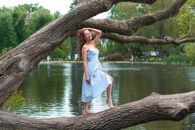 Beautiful woman in a blue dress in the park