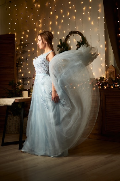 beautiful woman in blue evening dress Winter holidays concept