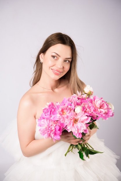 Beautiful woman bouquet of blossom peonies