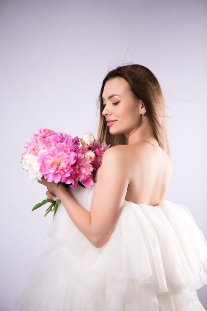 Beautiful woman bouquet of blossom peonies