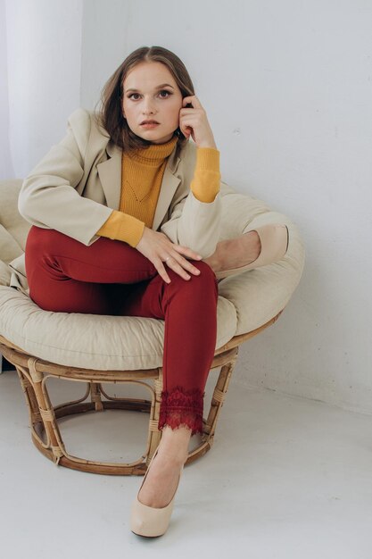 Beautiful woman businesswoman sitting in a chair at home