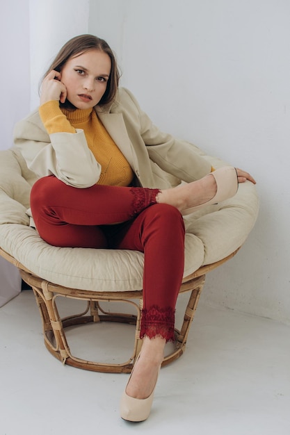 Beautiful woman businesswoman sitting in a chair at home