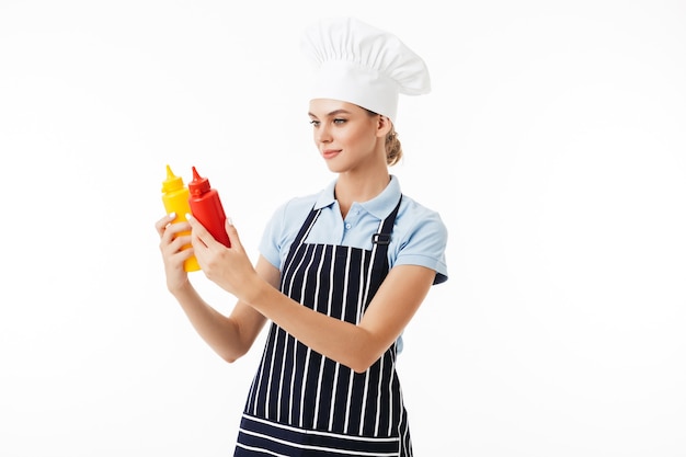 Beautiful woman chef in striped apron and white hat dreamily 