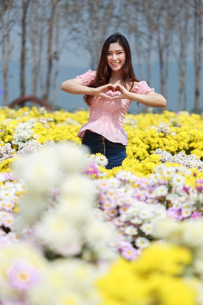 beautiful woman in chrysanthemum glower garden