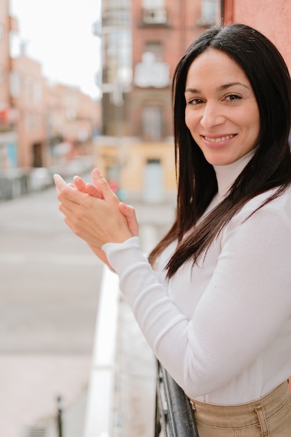 Beautiful woman clapping in the balcony