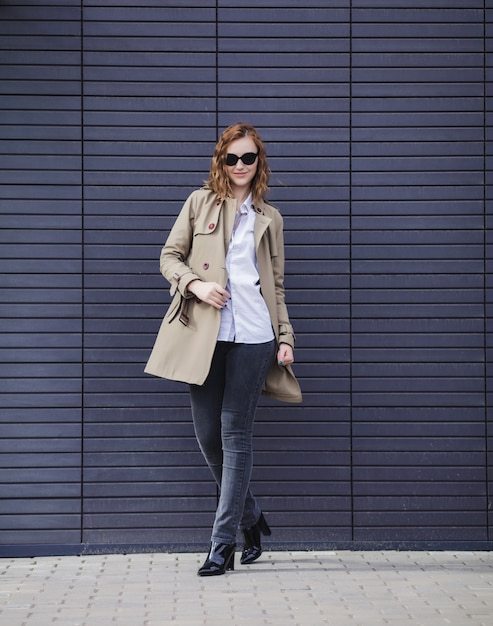 Beautiful woman in a coat and jeans