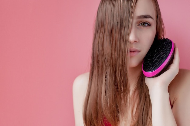 Beautiful Woman combs her Healthy Long Hair