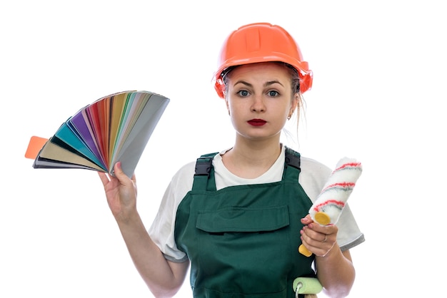 Beautiful woman in coverall with tools and color swatch