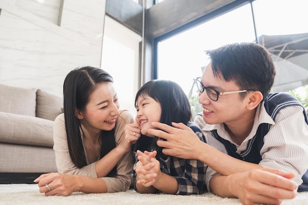 Beautiful woman And a cute girl Asians are eating milk and cornflakes Is a happy breakfast on the kitchen table at home It's a new normal life for the family