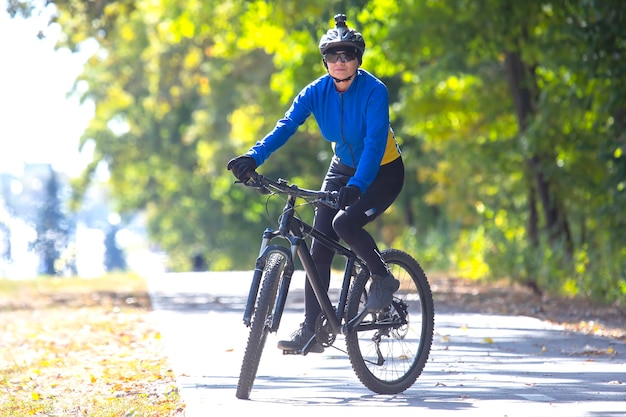 Beautiful woman cyclist rides a bicycle. Healthy lifestyle and sport. Leisure and hobbies