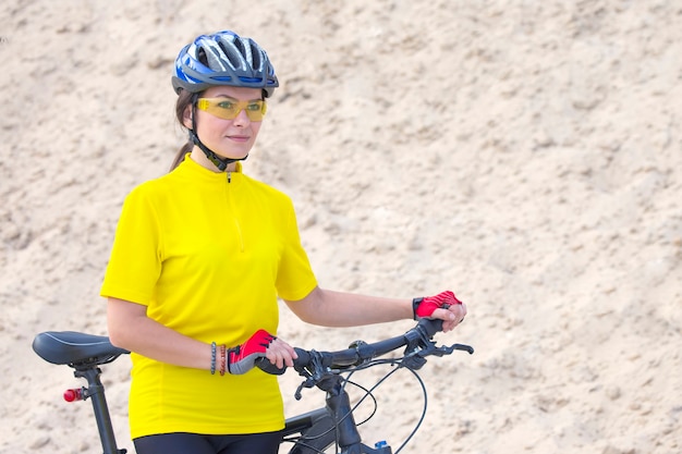 Beautiful woman cyclist with bike