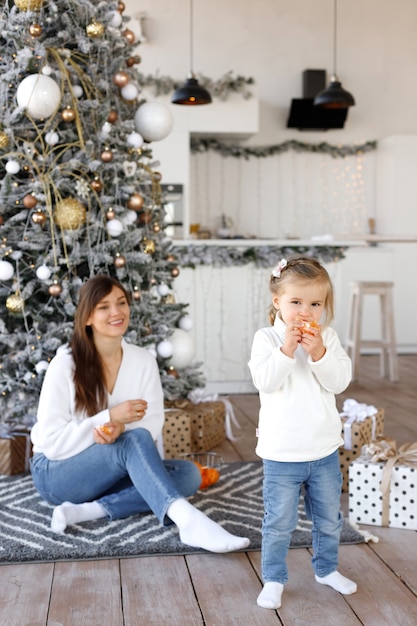 Beautiful woman and daughter on Christmas