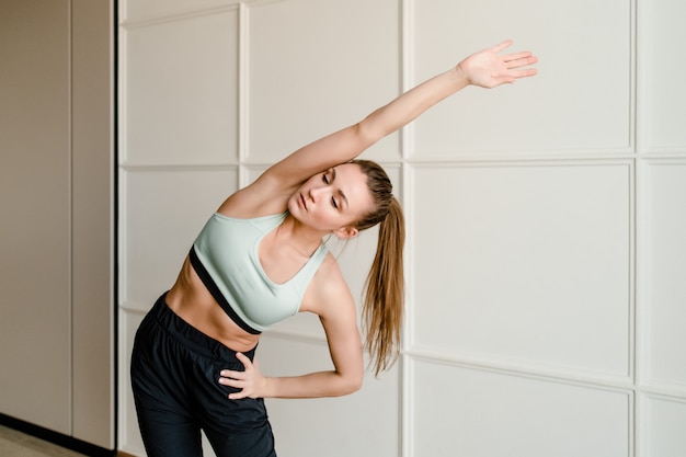 Beautiful woman doing sport at home