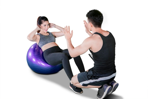 Beautiful woman doing workout with pilates ball