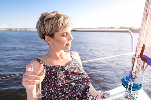 Beautiful woman in the dress resting at sea