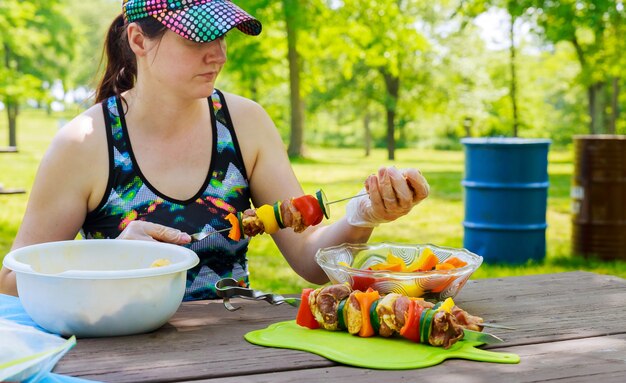 Beautiful woman dresses on a shish kebab skewers