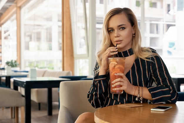 Beautiful woman drinking a cocktail