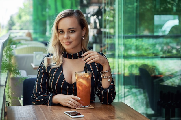 Beautiful woman drinking a cocktail