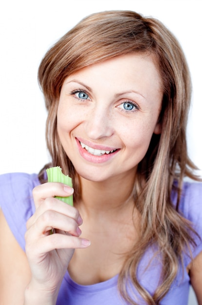 Beautiful woman eating celery 