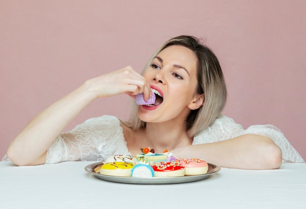 A beautiful woman eating cookies