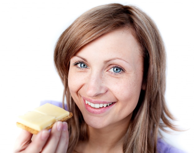 Beautiful woman eating a cracker with cheese