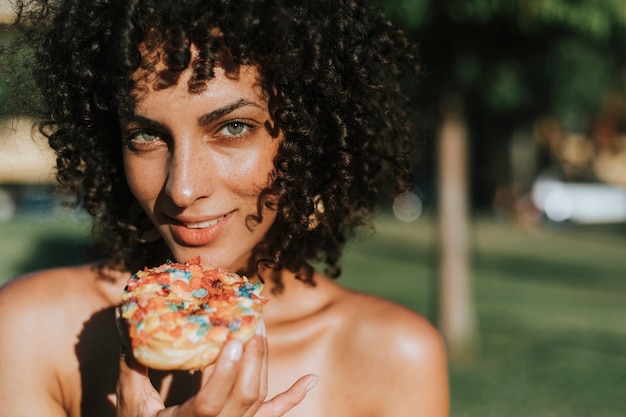 Beautiful woman eating a doughnut