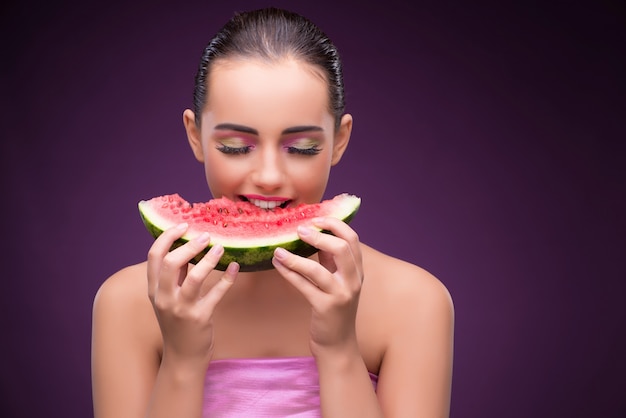 Beautiful woman eating tasty watermelon