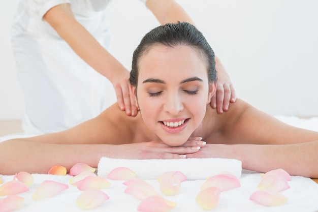 Beautiful woman enjoying back massage at beauty spa