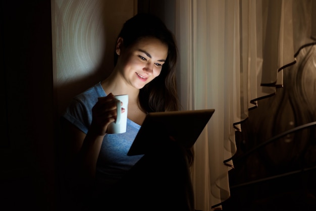 Beautiful woman enjoying a cup of coffee while relaxing at home