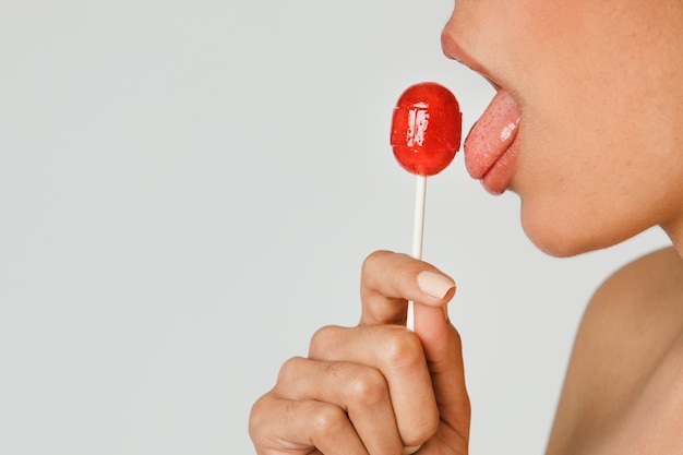 Beautiful woman enjoying a lollipop