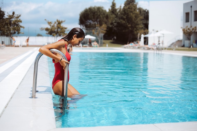 Beautiful woman enjoying the pool at the hotel