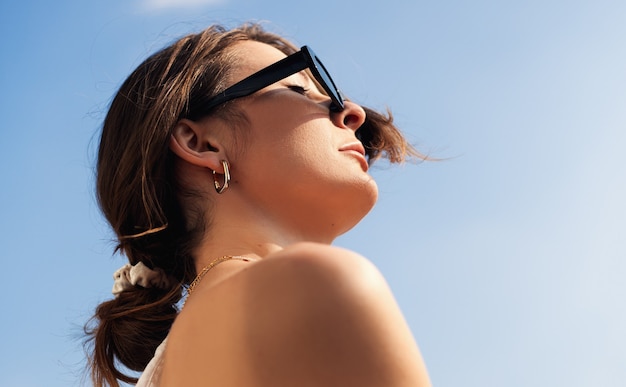 Beautiful woman enjoying sun lights