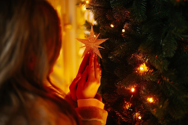 Beautiful woman enjoying winter holidays on Christmas market. Lights around.