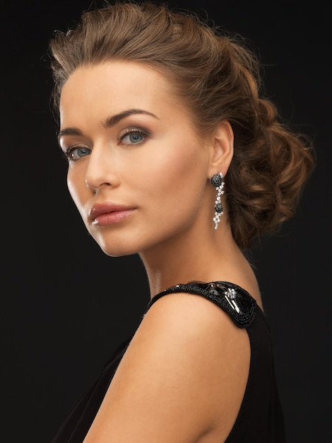 beautiful woman in evening dress wearing diamond earrings