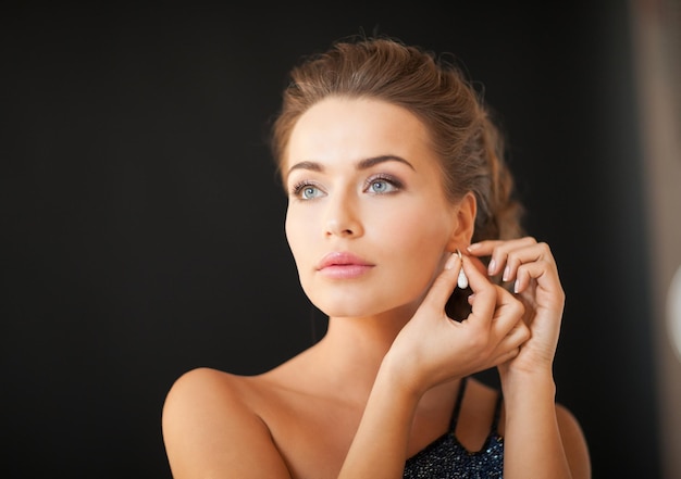 beautiful woman in evening dress wearing diamond earrings