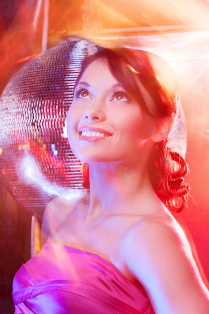 beautiful woman in evening dress with disco ball