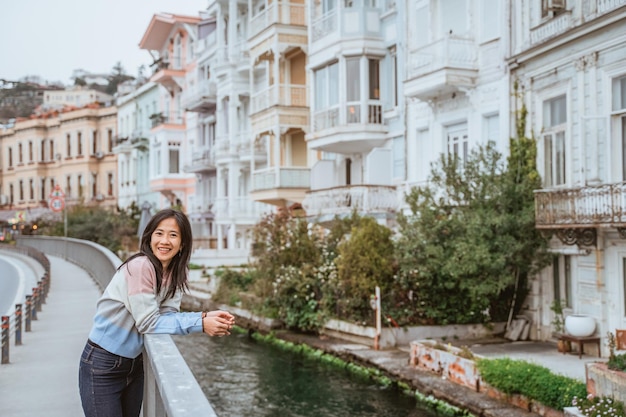 Beautiful woman exploring bebek bosphorus area enjoying the beauty of historical building in arnavut