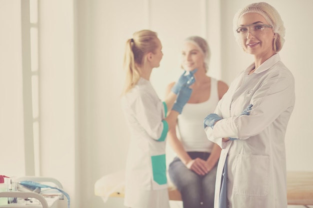 Beautiful woman face near doctor with syringe