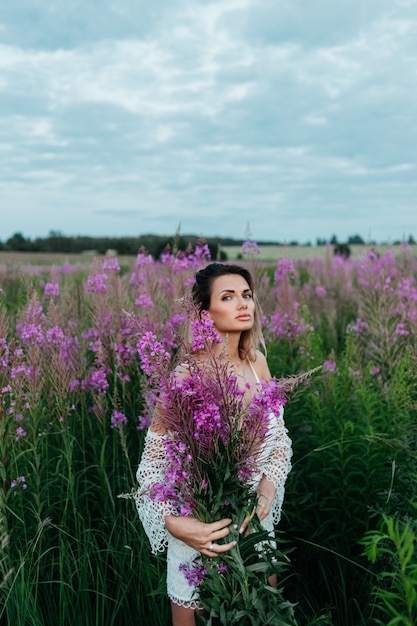Beautiful woman in a field of pink flowers. 