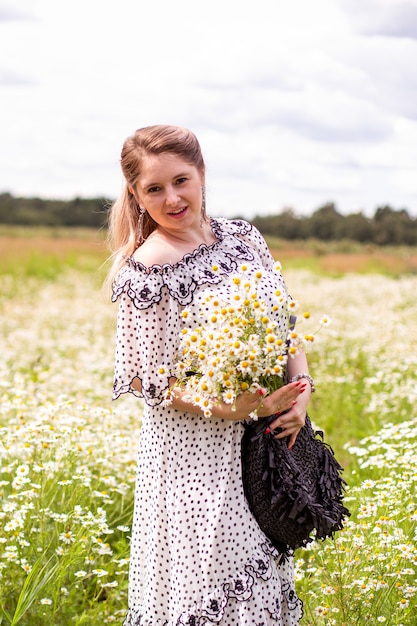 Красивая женщина в поле с цветами. Фото высокого качества