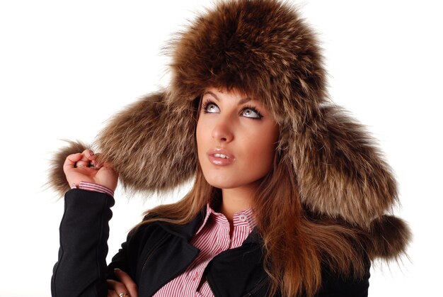 Beautiful woman in fur cap with ear flaps and bubos